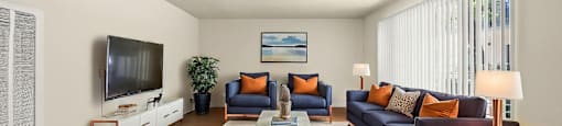 A living room with a dark blue sofa and a wooden coffee table.
