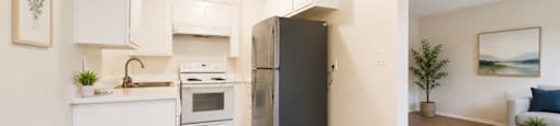 A modern kitchen with a refrigerator, sink, and cabinets.