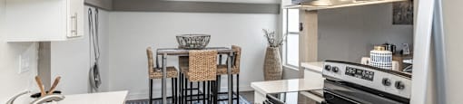 A modern kitchen with a dining table set up.