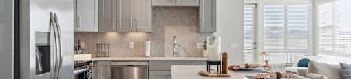 A modern kitchen with a large island and stainless steel appliances.