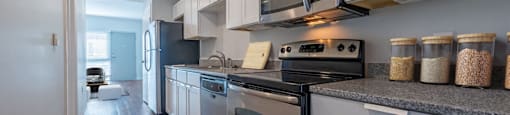 a kitchen with stainless steel appliances and white cabinets