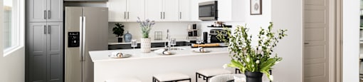 A modern kitchen with a dining table set for four.