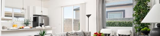 A modern living room with a grey sofa, a grey coffee table, and a white ceiling fan.