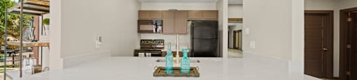 a kitchen with white countertops and a large island