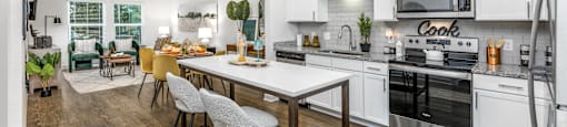 A modern kitchen with a dining table and chairs.