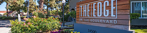 Edge on the Boulevard - Building Sign, Building Exterior, Tall Trees, and Landscape at The Edge on the Boulevard, California, 94555