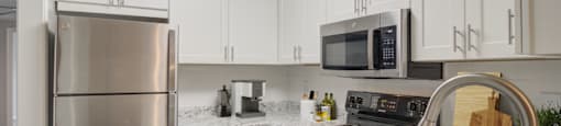 Upgraded kitchen with stainless steel appliances at Place at Midway apartments in Douglasville, GA