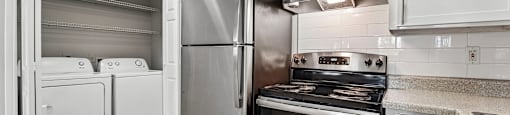 A modern kitchen with stainless steel appliances and white cabinets.