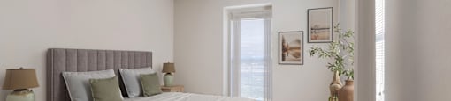 a bedroom with a large bed and a window
