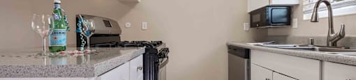 Fremont, CA Apartments Near Fremont Hub - Brookvale Chateau - Kitchen with Tile Floors, Granite-Style Countertops, and Stainless-Steel Appliances