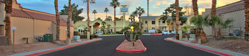 A street with palm trees on both sides and a red circle in the middle.