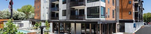 One-Bedroom Apartments in Santa Clara, CA - Santana Terrace - Apartment Building Exterior with Private Balconies, Beautiful Landscaping, and a Pool