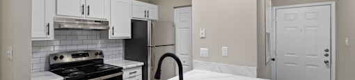 a kitchen with white cabinets and black appliances and a sink
