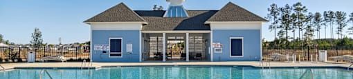 A large swimming pool in front of a pool house at 15 at Heron in Longs, SC.