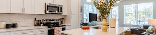 A modern kitchen with white cabinets and a large island.