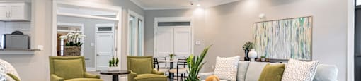 a living room with couches and chairs and a table