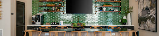 a dining room with a long table and chairs and a television