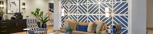 a living room with a couch and chairs and a rug