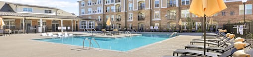 our apartments have a large pool with lounge chairs and umbrellas