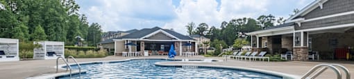 a large pool with a house in the background