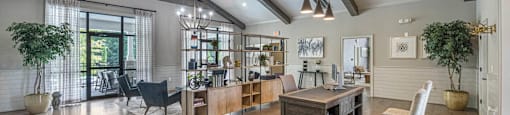 a large living room with exposed beams and a dining room table