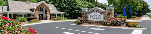 The entrance to a place called Folio with a sign and a building.