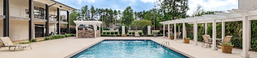 A large rectangular pool with a diving board in the middle.
