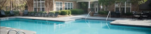 a large swimming pool in front of a house