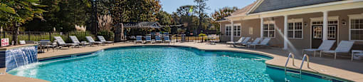 A large swimming pool with a sunny sky above.