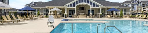 A large swimming pool with a slide and sun loungers.