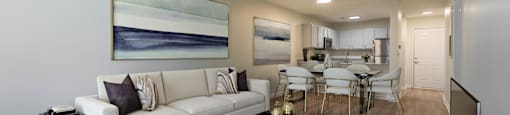 a living room with a couch and a coffee table in front of a dining room