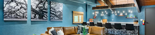 a living room with blue walls and leather furniture
