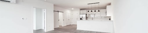 A spacious room with a grey floor and white walls.