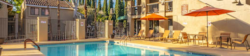 A pool with a building behind it.