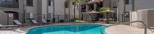 sunny pool area with apartments in background