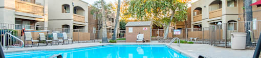 Tanglewood pool view with relaxation area and tall trees surrounding