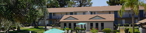 A large building with a pool in front of it.