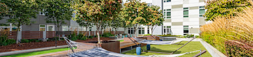 A modern building with a green lawn in front.