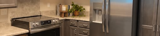 A modern kitchen with stainless steel appliances and wooden cabinets.
