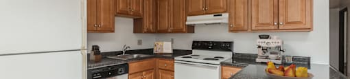 a kitchen with white appliances and granite counter tops