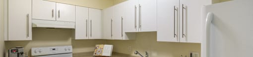 the preserve at ballantyne commons apartment kitchen with white cabinets and appliances at North Stoughton Village, Massachusetts, 02072