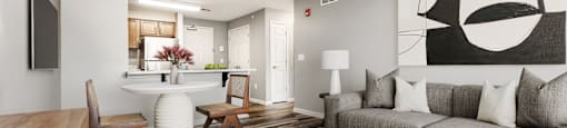 Living And Dining Area With Gray Couch And Ottoman at Niagara Square, Buffalo, 14201