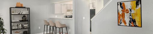 a living room with a table and chairs and a kitchen