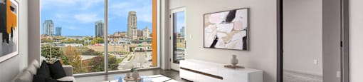 an open living room with a view of the city