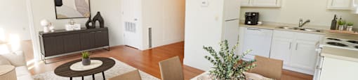 a living room and dining room with a table and chairs