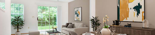 a living room and dining room with a table and chairs