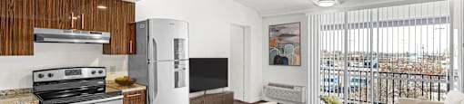 A modern kitchen with a stove top oven and a refrigerator.