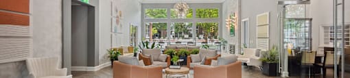a living room with couches and chairs and a large window