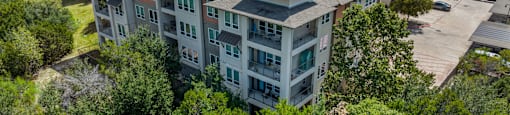 A bird's eye view of apartment buildings surrounded by trees.