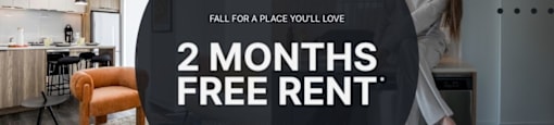 A woman is standing in a modern kitchen with a 2 months free rent offer.